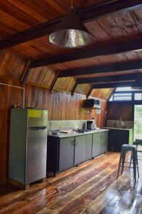 a large kitchen with wooden walls and wooden floors at Quinta Túru in Colonia