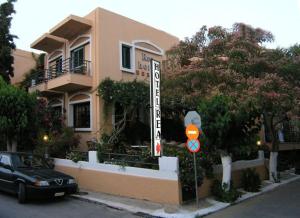 a black car parked in front of a building at Rea Hotel in Palaiochora
