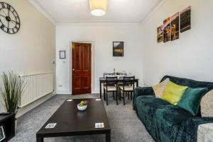 a living room with a couch and a table at Caledonia Suite - Netflix Free Parking in Glasgow