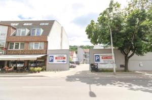 a building with two parking signs in front of a street at Apatmnán FelliniHouse in Trenčín