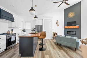 a kitchen with white cabinets and a island with a table at Lakeside, Water-view, 7 miles to Ark, 4BR for 14 in Williamstown