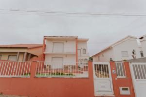 una casa blanca y naranja con una valla en Best Houses 107 - Ferrel Village House, en Ferrel