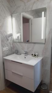a bathroom with a white sink and a mirror at Appartamenti Borghetto Panigale in Bologna