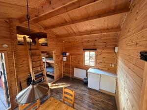 a log cabin with a desk and bunk beds at Steiner's Camping & Lodge in Johannisholm