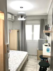 a hospital room with a bed and a chair at New elegant Studio in the center of Thessaloniki in Thessaloniki