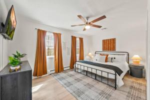 a bedroom with a bed and a ceiling fan at Boho Haven Hideaway - Walk to Pool,Theater,Arcades, Firepit, Lake Access in Thornhurst +49 photos