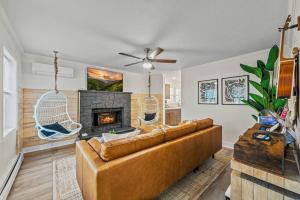 a living room with a couch and a fireplace at Boho Haven Hideaway - Walk to Pool,Theater,Arcades, Firepit, Lake Access in Thornhurst