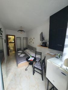 a small room with a bed and a table and chairs at St.Barbara studio in Drama