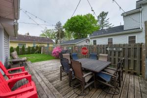 a patio with a table and chairs on a deck at Summer Haven- Walk to beach & Town from this 4 bedroom 2 bath Coastal Cottage in South Haven