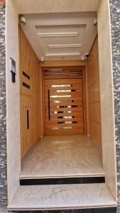 a large wooden garage door in a building at Résidence Bario H in Al Hoceïma