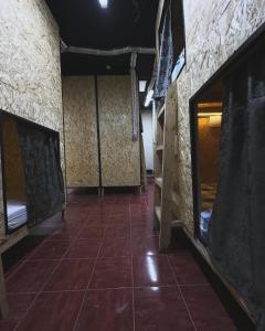a room with bunk beds and a tiled floor at Хата - капсульный отель, хостел in Akbulak