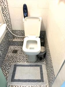 a bathroom with a white toilet and a sink at New elegant Studio in the center of Thessaloniki in Thessaloniki