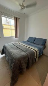 Ένα ή περισσότερα κρεβάτια σε δωμάτιο στο Pousada Pé na Areia Rio das Ostras