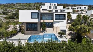 an aerial view of a house with a swimming pool at Villa Night Pearl in Trogir