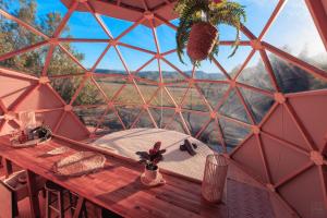 a table in a geodesic dome with a view at Tente évasion in Tuchan