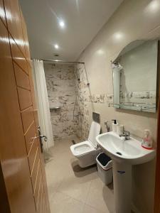 a bathroom with a sink and a toilet at Résidence Bario H in Al Hoceïma +75 photos