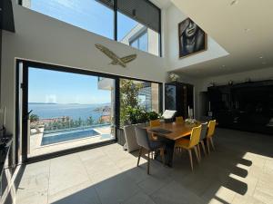 a dining room with a table and a view of the ocean at Villa Night Pearl in Trogir