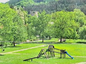a playground in a grassy field with a slide at Sobe Zizi in Jajce