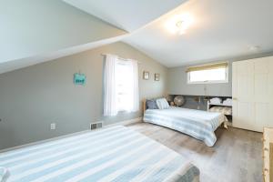 a bedroom with two beds and a window at Firefly Cottage - close to beach & town! in South Haven