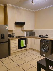 a kitchen with a refrigerator and a dishwasher at Grace Haven in Sandton