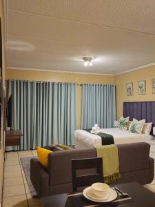 a living room with two beds and a couch at Grace Haven in Sandton