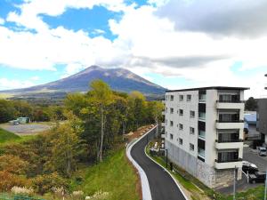 a building and a road with a mountain in the background at The Freshwater in Niseko