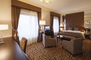 a hotel room with a bed and a table and chairs at Okura Chiba Hotel in Chiba