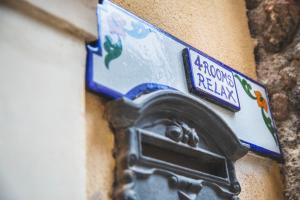 a mailbox on the side of a building with a street sign at 4Roomsrelax in Catania