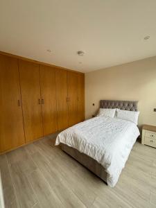 a bedroom with a large bed and wooden cabinets at Claret and Blue Inn in London