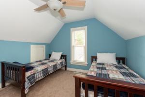 a bedroom with two beds and a ceiling fan at Lake Life - located just steps to South Beach in South Haven