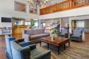 a living room with a couch and chairs and a table at Best Western Plus Edmonds Harbor Inn in Edmonds