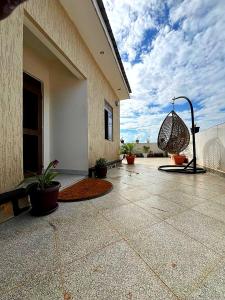 a patio of a building with a swing at Kindiha homes. in Seeta