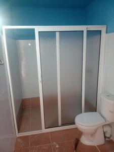 a bathroom with a toilet and a shower stall at Villa en el campo sobre el mar in Ras El Ma +18 photos