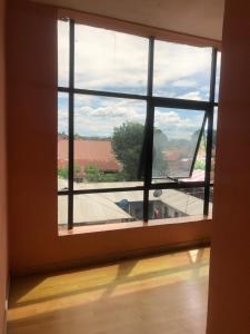 a large window in a room with a view at Despacito Hotel in Tanga