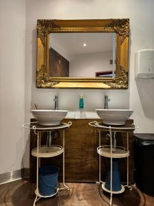 a bathroom with two sinks and a mirror at Nature & Beach Resort Aldeamento Turístico do Camarido in Caminha