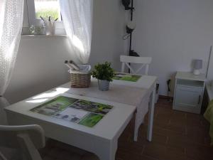- une table blanche dans une pièce avec une plante dans l'établissement Marija- ground floor studio next to the beach, à Betina