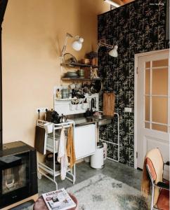 a room with a kitchen with a counter and a stove at Deborah's Hiding Place in Alkmaar +48 photos