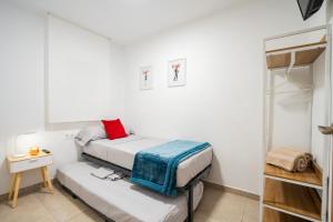 a small bedroom with two beds and a table at Home365 Barberá del Vallés Barcelona in Barbera del Valles