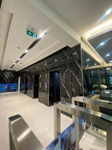 a lobby of a building with black marble walls at Kass Towers, Studio Apartment in Accra