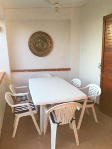 - une table et des chaises blanches dans la chambre dans l'établissement Casa Indipendente Praialonga, à Le Castella