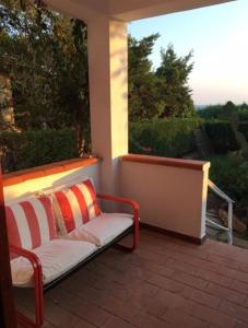 une terrasse couverte avec un canapé et une grande fenêtre dans l'établissement Casa Indipendente Praialonga, à Le Castella