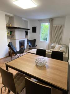 a living room with a wooden table and chairs at Casa Lilia in Lugano