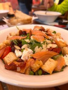 a white plate with a salad on a table at Pensiune Citadela Sighisoara in Sighişoara