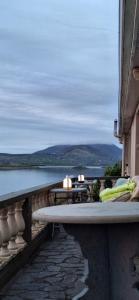 a balcony with a table and a view of the water at Horizon View Lodge Bed and Breakfast Glanleam Road Knightstown Valentia Island County Kerry V23 W447 Ireland in Valentia Island