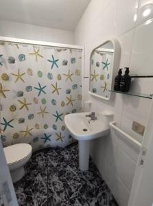 a bathroom with a sink and a toilet at Apartamentos Faxilda in Sanxenxo +44 photos