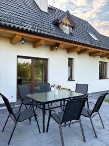 a black table and chairs on a patio at Osada Rzym in Gniew