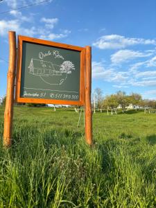 a sign in the middle of a field at Osada Rzym in Gniew