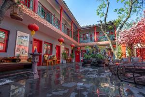 a courtyard of a building with red accents at Rong Hotel - Beijing Nanluoguxiang Branch in Beijing