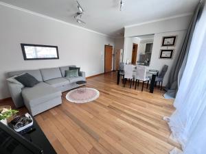 a living room with a couch and a table at Apartment Machico near the beach in Machico