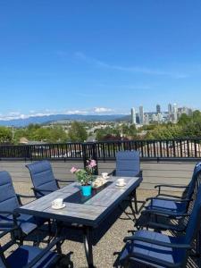 a table and chairs on a balcony with a view of the city at Panorama VistaVue Vancouver in Vancouver